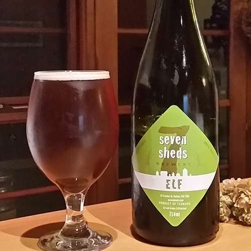 Seven Sheds ELF autumn ale packaged in a 750ml bottle beside a poured glass of the same beer.